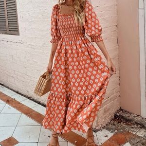 Tiered and smocked orange dress with puffy sleeves